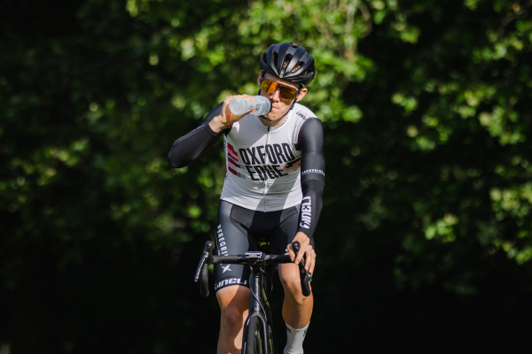 Tineli Ambassador Guy Yarrell drinking on road bike